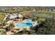 Resort-style community pool with lounge chairs, umbrellas, and lush tropical landscaping at 8113 Key West Dove St, Winter Garden, FL 34787