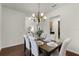 Dining room showcasing a wood table, upholstered chairs, decorative chandelier, and access to other rooms in the home at 8113 Key West Dove St, Winter Garden, FL 34787