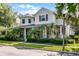 Charming two-story home with lush landscaping, red shutters, and a welcoming front porch with columns at 8113 Key West Dove St, Winter Garden, FL 34787