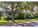 Lovely home exterior featuring a covered porch and lush landscaping, with a large tree in the front yard at 8113 Key West Dove St, Winter Garden, FL 34787