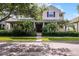 Charming two-story home with red shutters, covered porch, and lush landscaping at 8113 Key West Dove St, Winter Garden, FL 34787