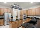 Spacious kitchen featuring granite countertops, stainless steel appliances, custom cabinetry, and a functional center island at 8113 Key West Dove St, Winter Garden, FL 34787