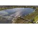 Scenic community lake with a wooden dock and walking trails, perfect for nature lovers at 8113 Key West Dove St, Winter Garden, FL 34787