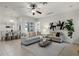 Bright living room with contemporary decor, neutral colors, tile floors, and adjacent dining area at 8113 Key West Dove St, Winter Garden, FL 34787