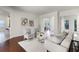 Stylish living room with neutral color palette, wood floors, and open view to other living spaces at 8113 Key West Dove St, Winter Garden, FL 34787