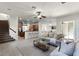 Cozy living room with stairs, open to the kitchen, and sliding doors to the outdoor patio at 8113 Key West Dove St, Winter Garden, FL 34787