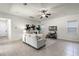 Inviting living room with neutral decor, ceiling fan, and large windows offering natural light at 8113 Key West Dove St, Winter Garden, FL 34787