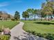 Peaceful walking path in a park-like setting with mature trees and scenic views at 8113 Key West Dove St, Winter Garden, FL 34787