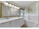 Bathroom showcasing a double vanity, soaking tub, walk-in shower and decorative touches at 871 Paddington Ter, Lake Mary, FL 32746