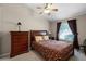 Comfortable bedroom with a ceiling fan, large window, and stylish furniture at 871 Paddington Ter, Lake Mary, FL 32746