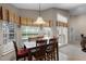 Bright dining area with large windows and a view of the backyard, perfect for Gathering meals at 871 Paddington Ter, Lake Mary, FL 32746