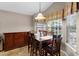 Formal dining room with elegant wood furniture, natural lighting, and neutral color scheme at 871 Paddington Ter, Lake Mary, FL 32746