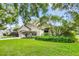 Charming single-story home featuring a lush front yard, mature trees, and well-manicured landscaping for enhanced curb appeal at 871 Paddington Ter, Lake Mary, FL 32746