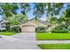 Charming single-story home with a well-maintained front yard and attached two-car garage at 871 Paddington Ter, Lake Mary, FL 32746
