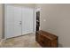 Entryway featuring tile floors, a wooden dresser, and double doors to a closet or storage area at 871 Paddington Ter, Lake Mary, FL 32746