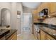 Kitchen featuring granite countertops, stainless appliances, and travertine floors at 871 Paddington Ter, Lake Mary, FL 32746