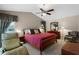 Spacious main bedroom boasts neutral paint, a vaulted ceiling with a ceiling fan and comfortable seating at 871 Paddington Ter, Lake Mary, FL 32746