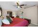Spacious main bedroom boasts neutral paint, a vaulted ceiling with a ceiling fan and comfortable seating at 871 Paddington Ter, Lake Mary, FL 32746