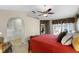 Spacious main bedroom with neutral paint, ceiling fan, ensuite bathroom and access to patio at 871 Paddington Ter, Lake Mary, FL 32746