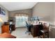 Home office with a large window, a desk with multiple monitors, and built-in shelving at 871 Paddington Ter, Lake Mary, FL 32746