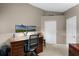 Functional home office with dual monitors, a rolling desk chair, and natural light at 871 Paddington Ter, Lake Mary, FL 32746