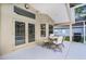 Covered outdoor patio area with table, chairs, and double doors leading to interior at 871 Paddington Ter, Lake Mary, FL 32746