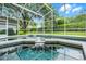 Enclosed swimming pool and patio with lush landscaping and blue skies at 871 Paddington Ter, Lake Mary, FL 32746