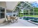 The pool is encased in a screen enclosure and a table with four chairs at 871 Paddington Ter, Lake Mary, FL 32746