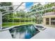 Beautiful screened-in pool with a spa and lush landscaping offers the perfect outdoor oasis at 871 Paddington Ter, Lake Mary, FL 32746