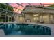 Enclosed pool area with a hot tub, lounge seating and a screened enclosure at 871 Paddington Ter, Lake Mary, FL 32746