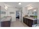 Well-lit bathroom featuring double vanities with granite countertops and tile flooring at 9025 Horizon Pointe Trl, Windermere, FL 34786