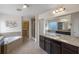 Spacious bathroom features a soaking tub, walk-in shower, granite counters, and walk-in closet at 9025 Horizon Pointe Trl, Windermere, FL 34786