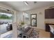 Bright dining area with modern lighting fixture, dining table, and access to the outdoor patio through sliding glass doors at 9025 Horizon Pointe Trl, Windermere, FL 34786