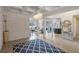 The grand entryway features a patterned rug and illuminated coffered ceiling leading into the living and kitchen areas at 9025 Horizon Pointe Trl, Windermere, FL 34786