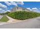 Home exterior featuring privacy landscaping with tall hedges under a sunny sky, providing seclusion and curb appeal at 9025 Horizon Pointe Trl, Windermere, FL 34786