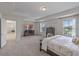 Spacious main bedroom with tray ceiling, large windows, and ample closet space at 9025 Horizon Pointe Trl, Windermere, FL 34786