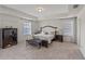Bright main bedroom with tray ceilings, carpeted floors, large windows, and stylish decor at 9025 Horizon Pointe Trl, Windermere, FL 34786