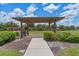 Community pergola offers shaded seating with landscaped surroundings, enhancing the outdoor experience with a peaceful ambiance at 9025 Horizon Pointe Trl, Windermere, FL 34786