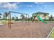 Community playground featuring swings, a slide, and a climbing structure set against a backdrop of well-manicured lawns at 9025 Horizon Pointe Trl, Windermere, FL 34786