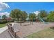 A community playground includes swings, slides and a wood chip safety surface with benches under a bright blue sky at 9025 Horizon Pointe Trl, Windermere, FL 34786