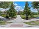 Community street view featuring a sidewalk with mature trees and landscaped areas, offering a peaceful neighborhood setting at 9025 Horizon Pointe Trl, Windermere, FL 34786