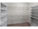 Spacious walk-in closet with custom shelving and ample storage space for organization at 9025 Horizon Pointe Trl, Windermere, FL 34786