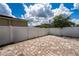 Paver patio in backyard with white vinyl fencing and lush tree creates private outdoor living space at 9115 Longship Aly, Orlando, FL 32832