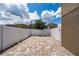 Paver backyard is surrounded by a white fence, perfect for outdoor entertaining and privacy at 9115 Longship Aly, Orlando, FL 32832