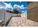 Spacious brick-paved backyard, perfect for outdoor gatherings, features a white fence for privacy and views of neighboring houses at 9115 Longship Aly, Orlando, FL 32832