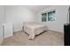 Comfortable bedroom with neutral carpet and paint, features a queen bed and a large window at 9115 Longship Aly, Orlando, FL 32832