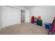 Spacious bedroom featuring neutral carpeting, an open doorway to the hallway, and a large closet for ample storage at 9115 Longship Aly, Orlando, FL 32832
