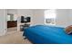Comfortable bedroom features a blue bedspread, large window, and en-suite bathroom, creating a relaxing and private space at 9115 Longship Aly, Orlando, FL 32832