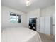 Bright bedroom with a bed, TV, closet, and a window view overlooking a serene lake at 9115 Longship Aly, Orlando, FL 32832