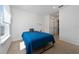 Inviting bedroom with a large window, neutral carpet, double door closet and blue accents for a serene atmosphere at 9115 Longship Aly, Orlando, FL 32832